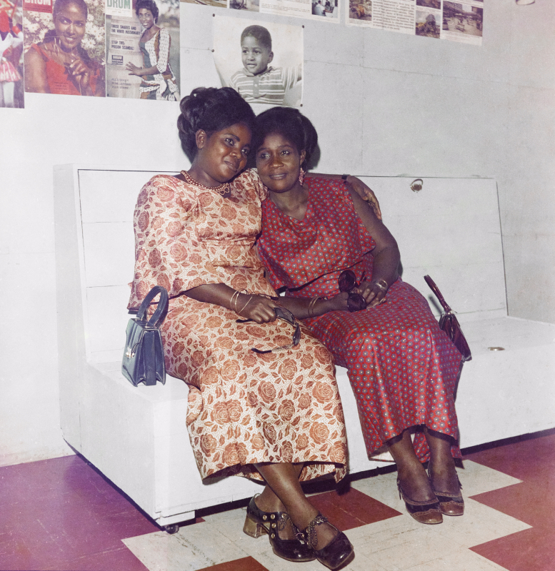 Figure 1. James Barnor, Untitled [portrait of two friends in front of covers of Drum], Accra, c. 1972 