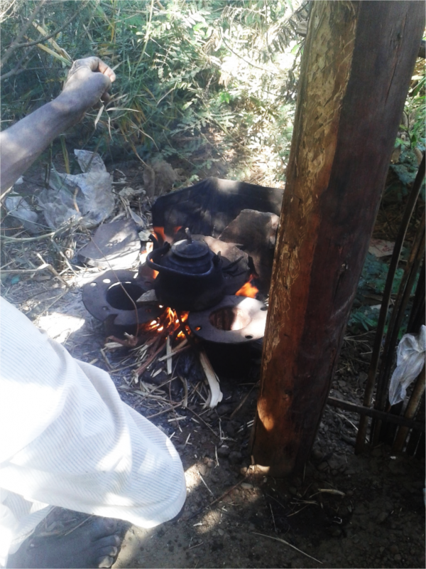 Image 3. Making tea using dry leaves, with enclosure to prevent fire from spreading on Difoinarti